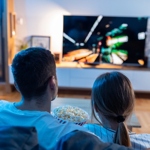 young couple watch film at romantic night in apartment and eat popcorn TV Evolution